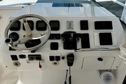 Slide: The Image of 2013 Intrepid 430 Sport Yacht helm with steering wheel and control panel. - 18