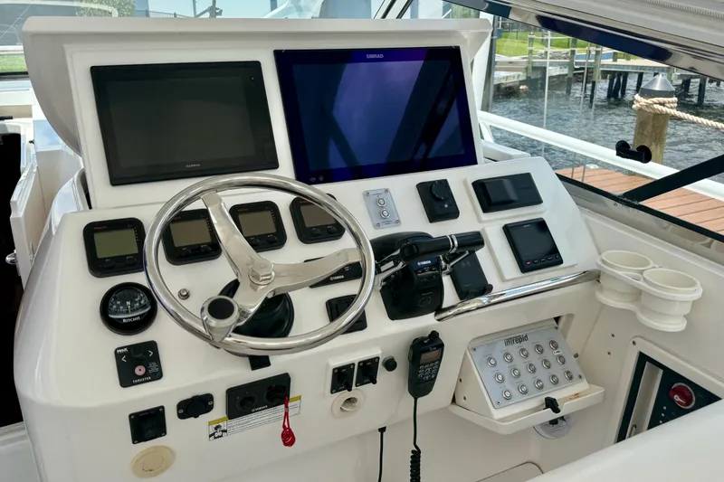 Slide: The Image of Helm of 2013 Intrepid 430 Sport Yacht with advanced navigation controls and displays. - 19