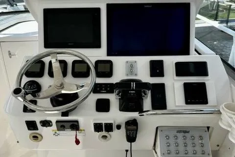 Slide: The Image of Control panel of a 2013 Intrepid 430 Sport Yacht with steering wheel and navigation screens. - 20