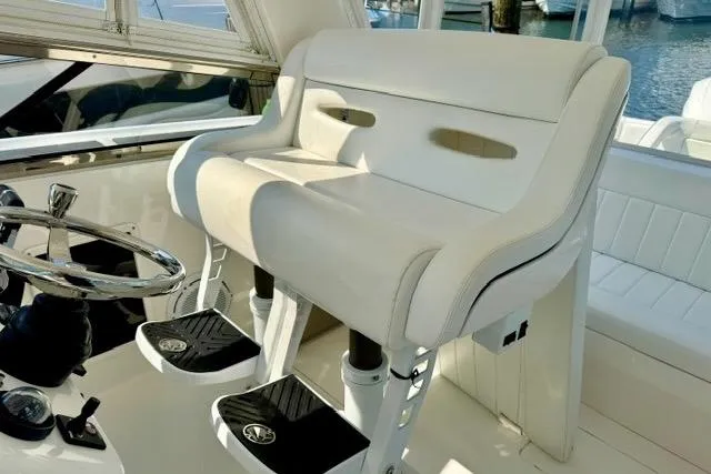 Slide: The Image of Luxurious helm seating on 2013 Intrepid 430 Sport Yacht, featuring sleek design and premium materials. - 21