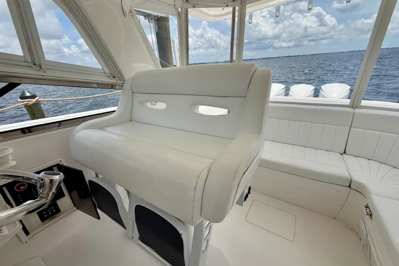 Slide: The Image of Luxurious interior of 2013 Intrepid 430 Sport Yacht with white seating and ocean view. - 22