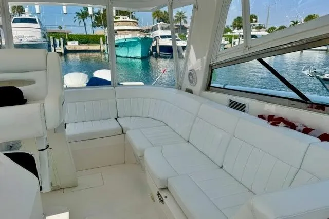 Slide: The Image of Luxurious interior of 2013 Intrepid 430 Sport Yacht with white seating and marina view. - 23