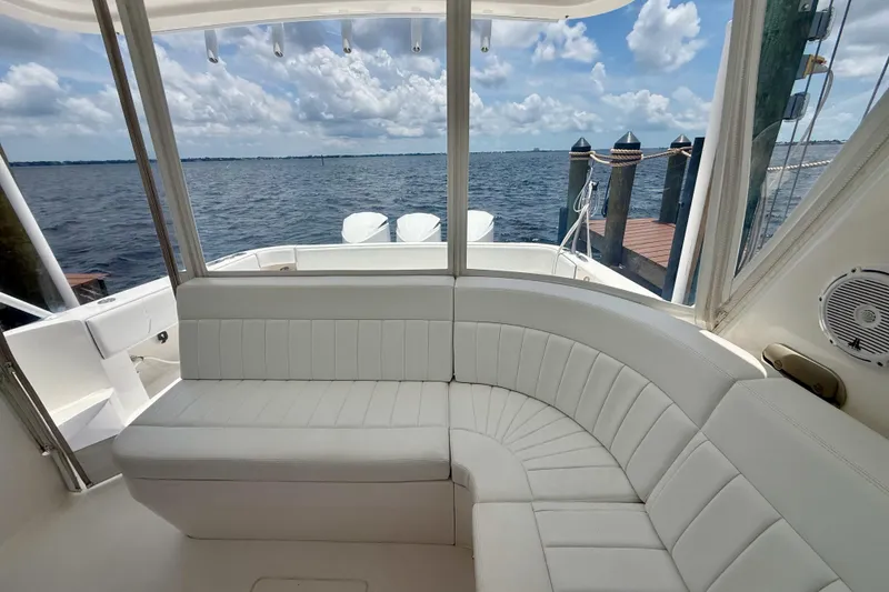 Slide: The Image of Luxurious seating on 2013 Intrepid 430 Sport Yacht with ocean view and dock in background. - 24