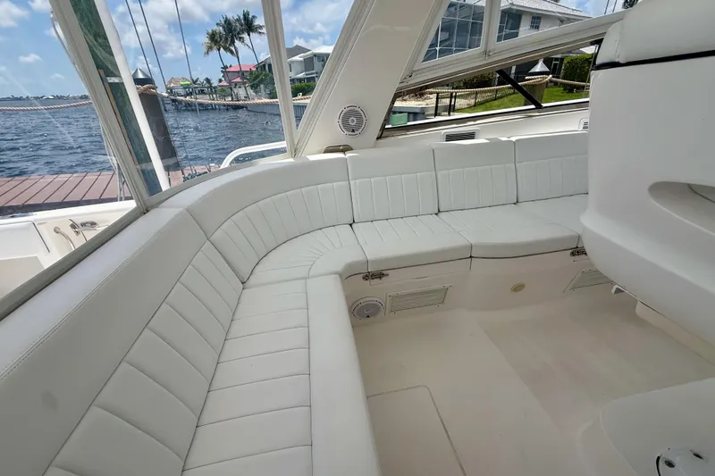 Slide: The Image of Luxurious white seating area on a 2013 Intrepid 430 Sport Yacht, docked by the water. - 25