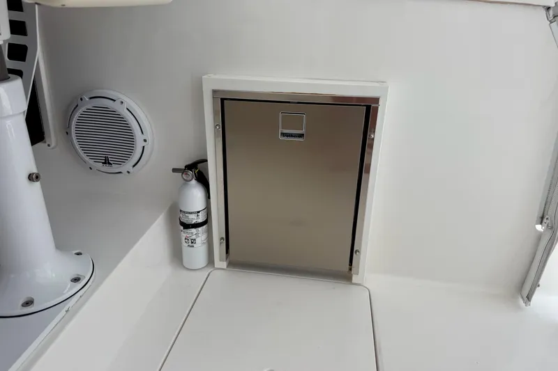 Slide: The Image of 2013 Intrepid 430 Sport Yacht interior with fire extinguisher and stainless steel compartment. - 26