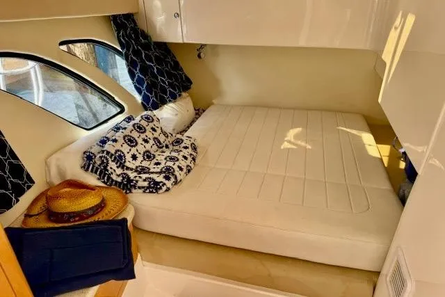 Slide: The Image of Cozy cabin interior of 2013 Intrepid 430 Sport Yacht with bed and nautical decor. - 32