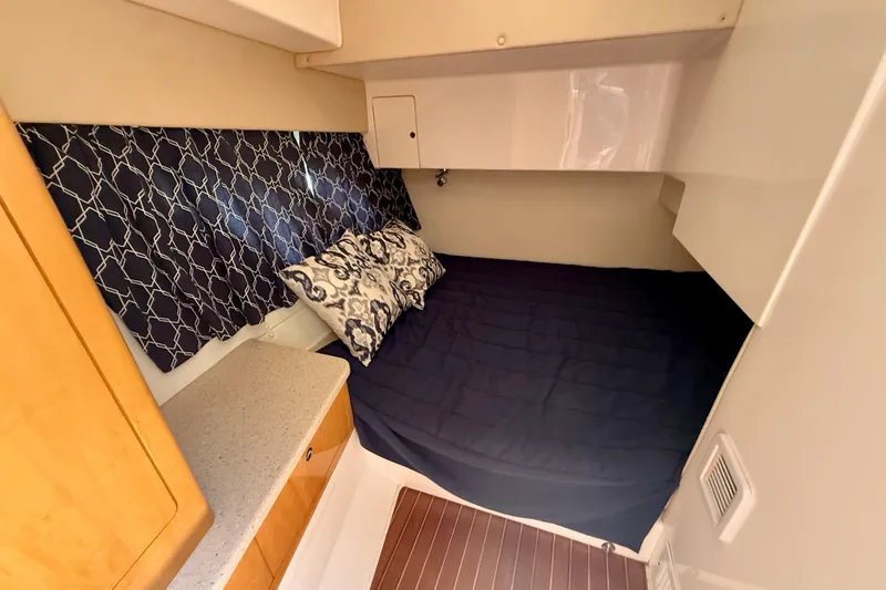 Slide: The Image of Cozy cabin interior of 2013 Intrepid 430 Sport Yacht with stylish bedding and wood accents. - 33
