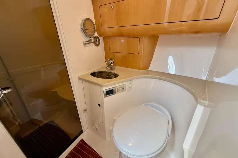 Slide: The Image of Luxurious bathroom in 2013 Intrepid 430 Sport Yacht with modern fixtures and wood accents. - 35