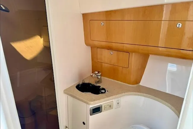 Slide: The Image of Interior of 2013 Intrepid 430 Sport Yacht featuring wooden cabinetry and modern amenities. - 36