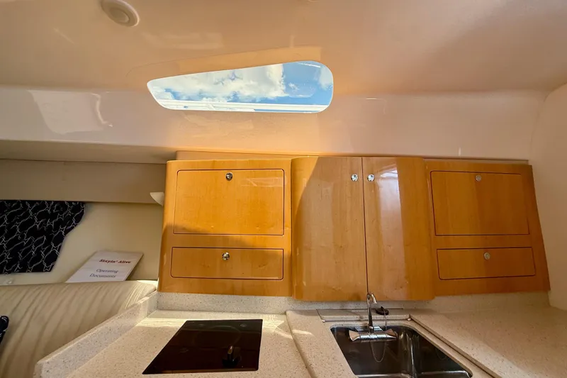 Slide: The Image of Interior of 2013 Intrepid 430 Sport Yacht with wooden cabinets and skylight. - 37