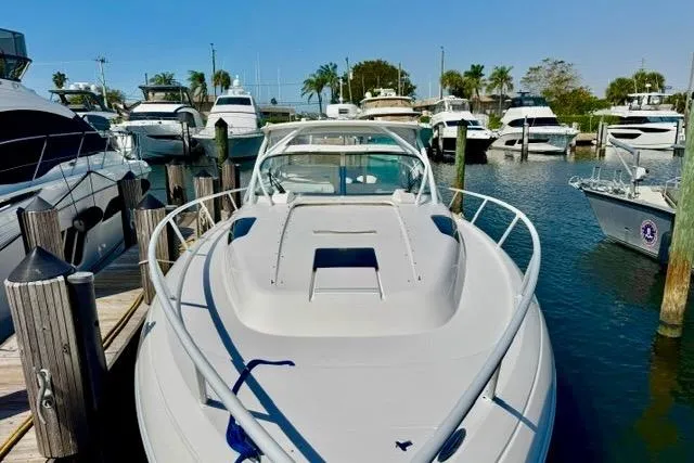 Slide: The Image of 2013 Intrepid 430 Sport Yacht docked among other boats in a sunny marina. - 5
