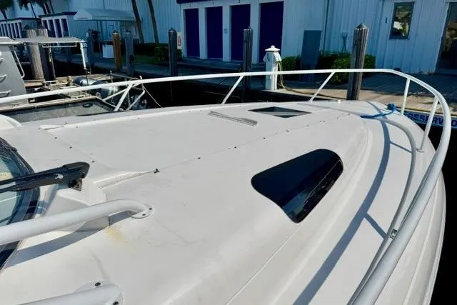 Slide: The Image of 2013 Intrepid 430 Sport Yacht docked, showcasing sleek deck design and railing. - 6