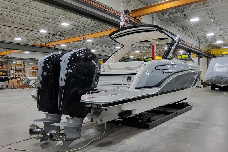 Slide: The Image of 2026 Formula 360 Crossover Bowrider OB in a showroom with dual outboard engines. - 6
