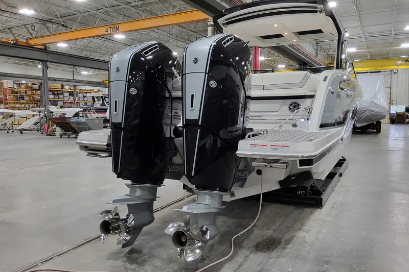 Slide: The Image of 2026 Formula 360 Crossover Bowrider OB with dual outboard engines in a warehouse setting. - 7