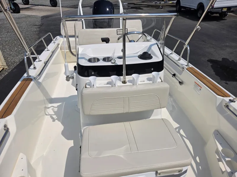 Slide: The Image of The image shows the cockpit of a 2027 Boston Whaler 170 Montauk with white seating and helm console. - 13