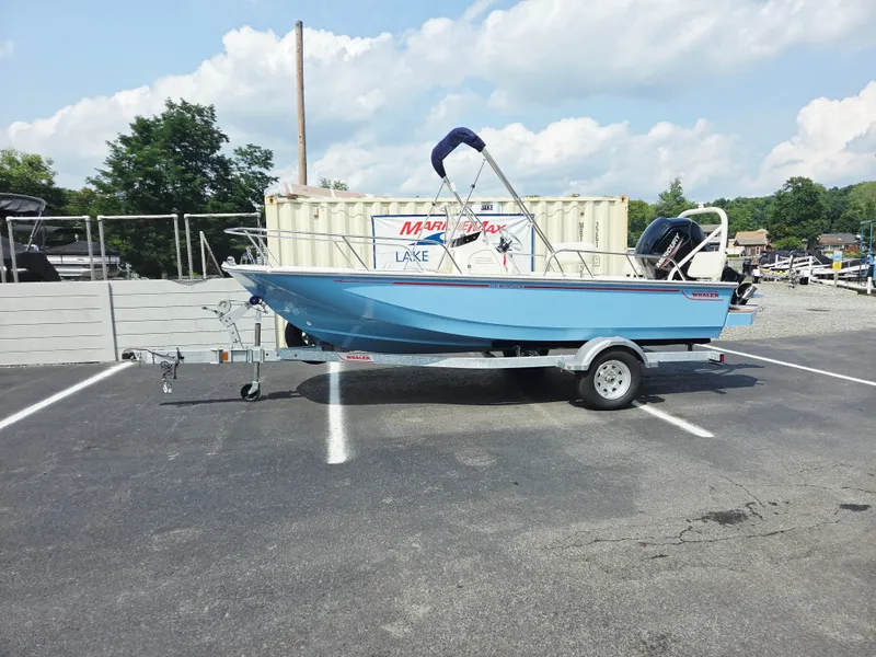 Slide: The Image of A blue 2027 Boston Whaler 170 Montauk sits on a trailer in a parking lot. - 2