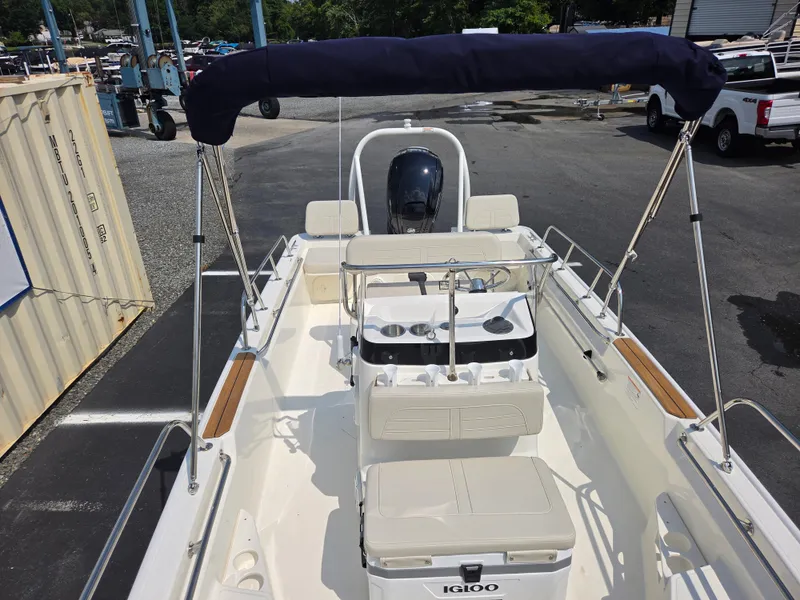 Slide: The Image of The image shows a 2027 Boston Whaler 170 Montauk boat with a simple, open deck design. - 15