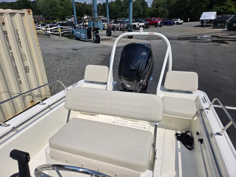 Slide: The Image of The image shows the cockpit of a 2027 Boston Whaler 170 Montauk with white seating and an outboard motor. - 22