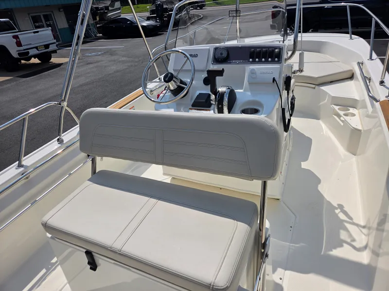 Slide: The Image of The image shows the cockpit of a 2027 Boston Whaler 170 Montauk with a helm and seating. - 26