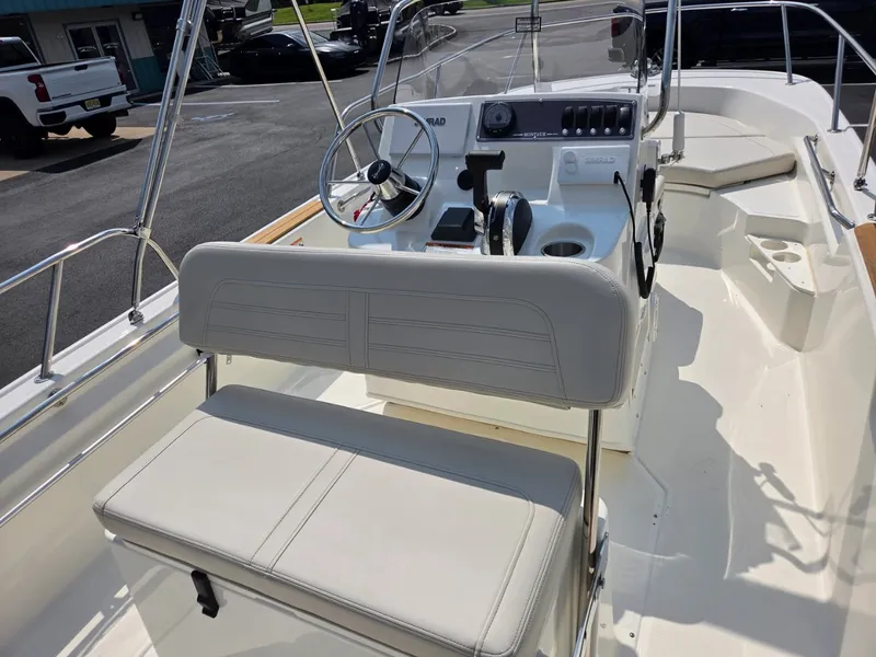 Slide: The Image of The image shows the cockpit of a 2027 Boston Whaler 170 Montauk with a helm and seating. - 23
