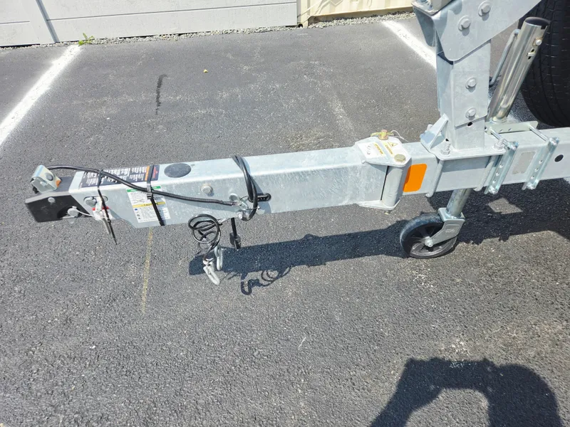 Slide: The Image of Close-up of a boat trailer on a concrete parking lot. - 10