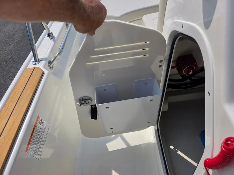 Slide: The Image of An open storage compartment on a 2027 Boston Whaler 170 Montauk boat. - 21