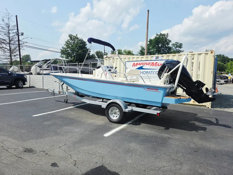 Slide: The Image of A blue 2027 Boston Whaler 170 Montauk sits on a trailer in a parking lot. - 4