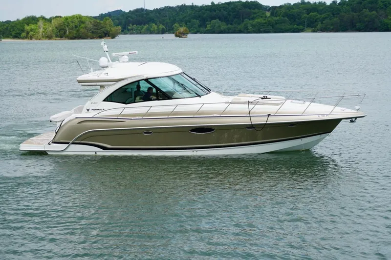 The Image of 2016 Formula 45 Yacht cruising on a serene lake with lush green surroundings. - 1