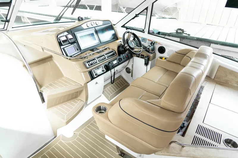Slide: The Image of Interior cockpit of 2016 Formula 45 Yacht with beige leather seating and advanced navigation controls. - 11