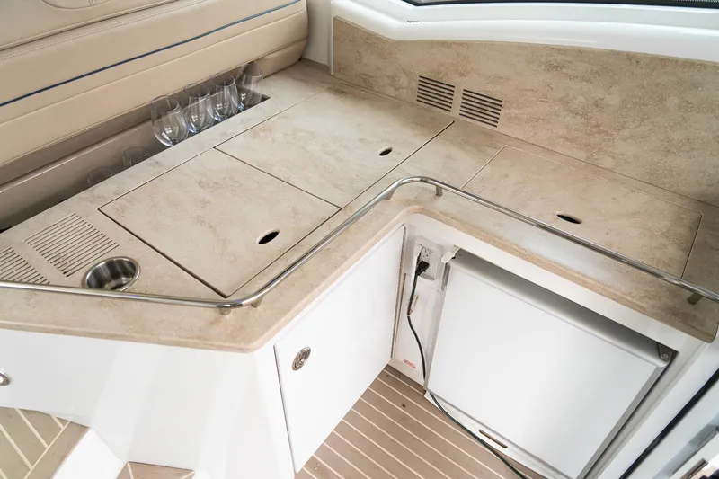 Slide: The Image of Luxurious 2016 Formula 45 Yacht interior with kitchenette, featuring beige countertops and built-in appliances. - 29
