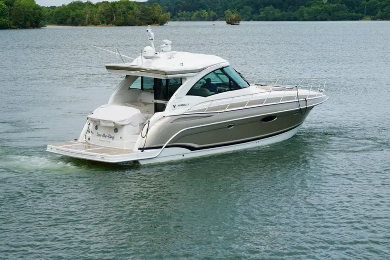 Slide: The Image of 2016 Formula 45 Yacht cruising on a serene lake with lush green surroundings. - 3