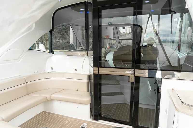 Slide: The Image of 2016 Formula 45 Yacht interior with beige seating and glass doors. - 31