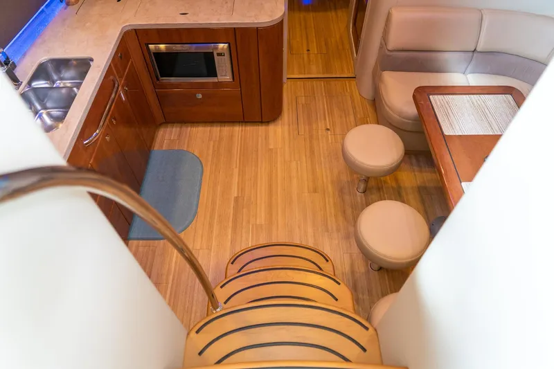 Slide: The Image of Interior of 2016 Formula 45 Yacht featuring kitchen, seating area, and wooden flooring. - 37