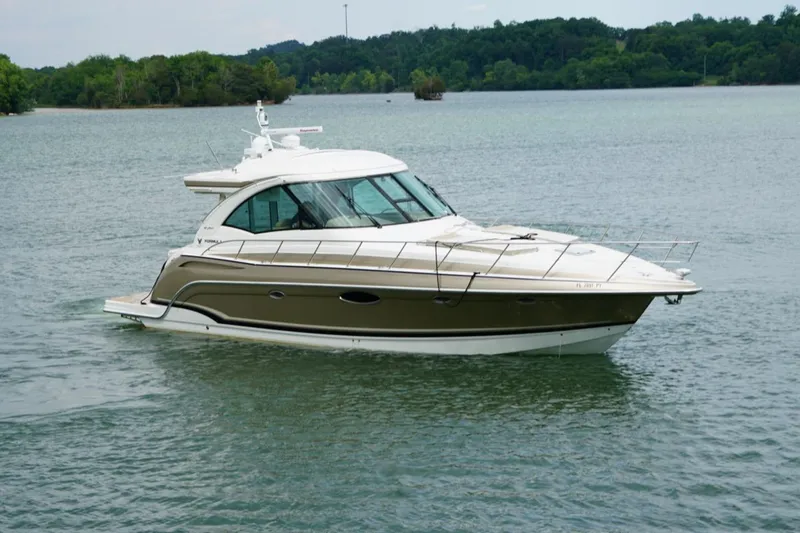 Slide: The Image of 2016 Formula 45 Yacht cruising on a serene lake with lush green shoreline. - 4