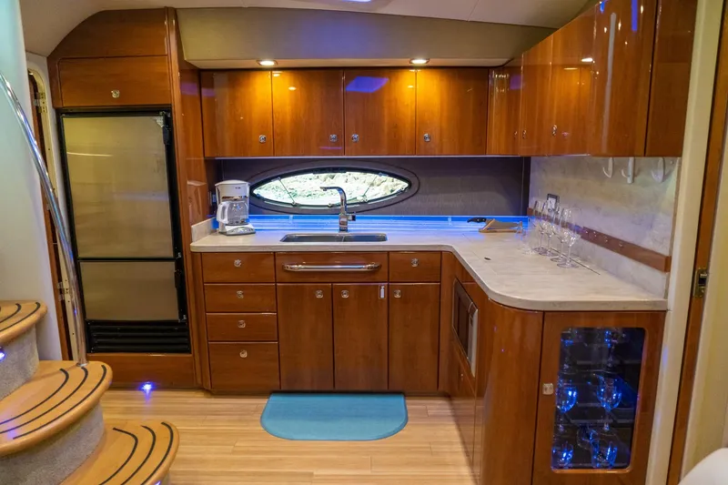 Slide: The Image of Luxurious 2016 Formula 45 Yacht kitchen with wood cabinetry and modern appliances. - 45