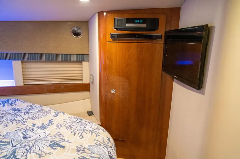 Slide: The Image of Interior of 2016 Formula 45 Yacht cabin with wood paneling and entertainment system. - 55