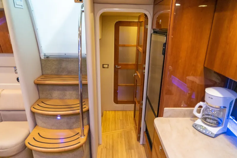 Slide: The Image of Interior of 2016 Formula 45 Yacht with wooden stairs and kitchenette. - 58
