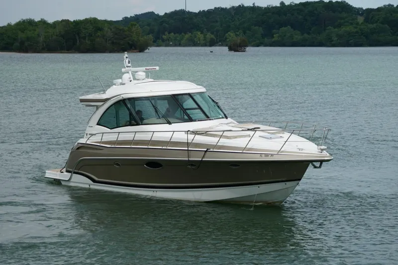 Slide: The Image of 2016 Formula 45 Yacht cruising on a serene lake with lush green shoreline. - 6