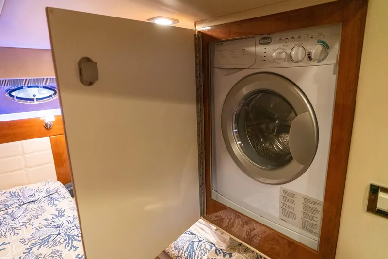 Slide: The Image of Laundry area inside 2016 Formula 45 Yacht, featuring a built-in washing machine. - 62