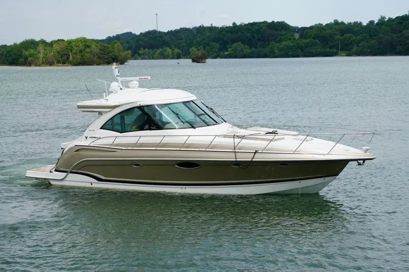 Slide: The Image of 2016 Formula 45 Yacht cruising on a serene lake with lush green shoreline. - 9