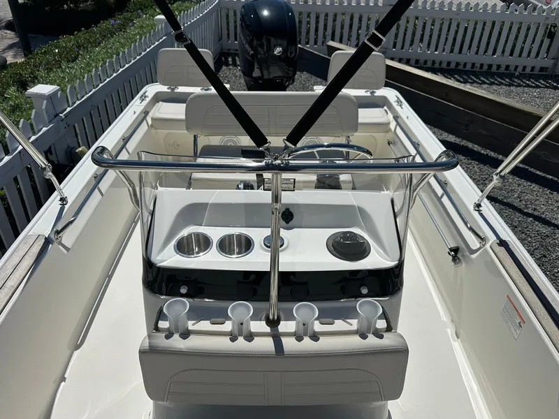 Slide: The Image of The image shows the cockpit of a 2027 Boston Whaler 170 Montauk with a console and seating. - 9