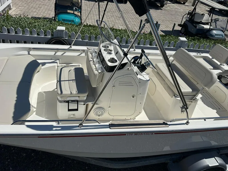 Slide: The Image of The image shows a 2027 Boston Whaler 170 Montauk boat with a clean, open deck. - 7