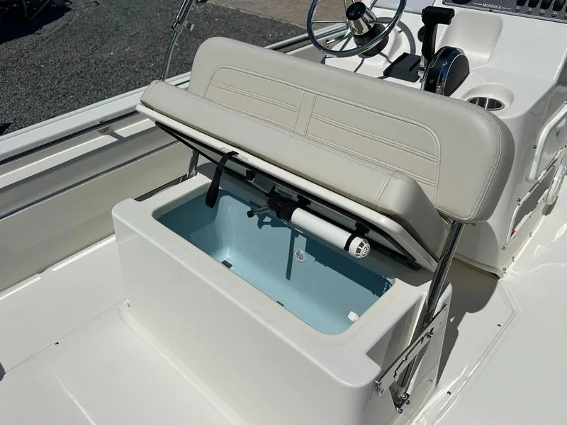 Slide: The Image of The 2027 Boston Whaler 170 Montauk features a cushioned bench seat with storage underneath. - 14