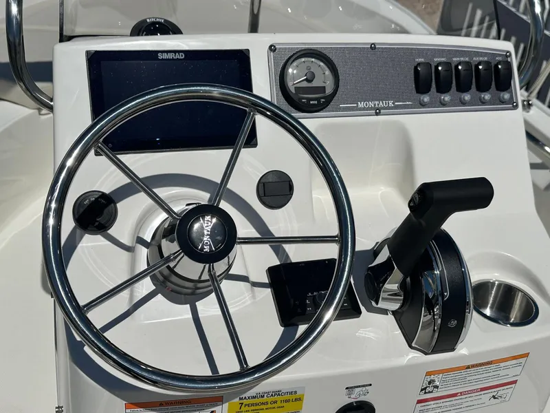 Slide: The Image of The image shows the helm of a Boston Whaler 170 Montauk with a steering wheel and instruments. - 11