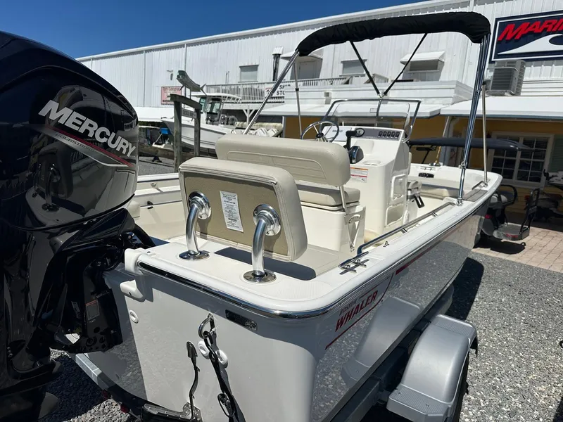 Slide: The Image of A 2027 Boston Whaler 170 Montauk with a Mercury outboard motor, parked on a trailer. - 5