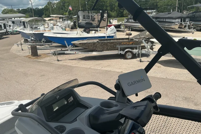 Slide: The Image of 2023 Sea-Doo Switch Sport Compact with Garmin GPS, parked near various boats. - 12