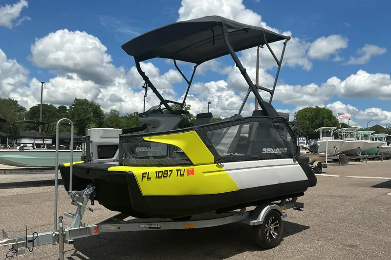 Slide: The Image of 2023 Sea-Doo Switch Sport Compact on trailer under blue sky with clouds. - 20