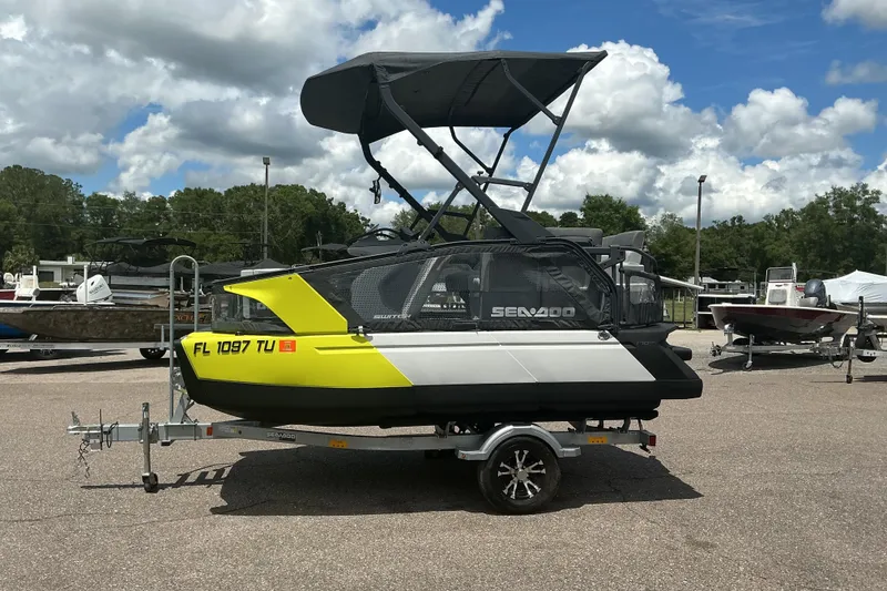 Slide: The Image of 2023 Sea-Doo Switch Sport Compact on trailer, parked outdoors under cloudy sky. - 21