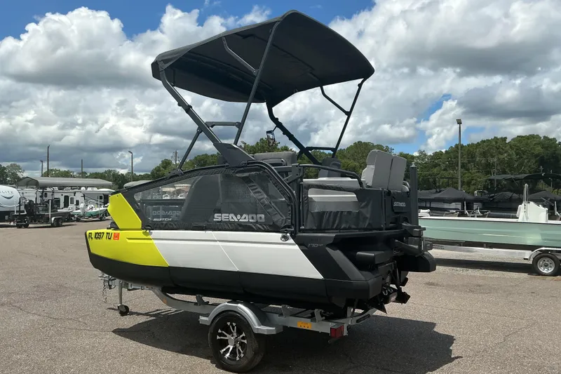 Slide: The Image of 2023 Sea-Doo Switch Sport Compact on trailer, parked outdoors under cloudy sky. - 22