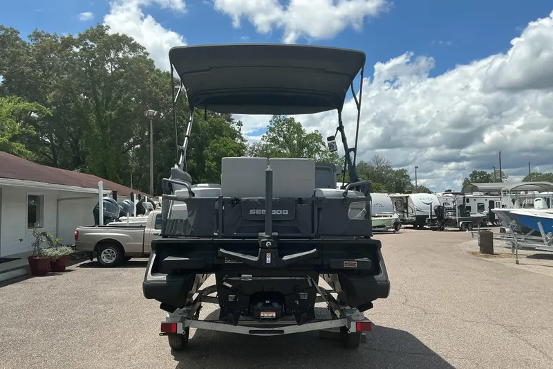 Slide: The Image of 2023 Sea-Doo Switch Sport Compact on trailer, parked outdoors under a cloudy sky. - 24